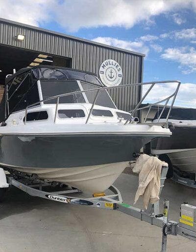 Finished boat restoration. Grey and white boat at Mullies Underwater Services