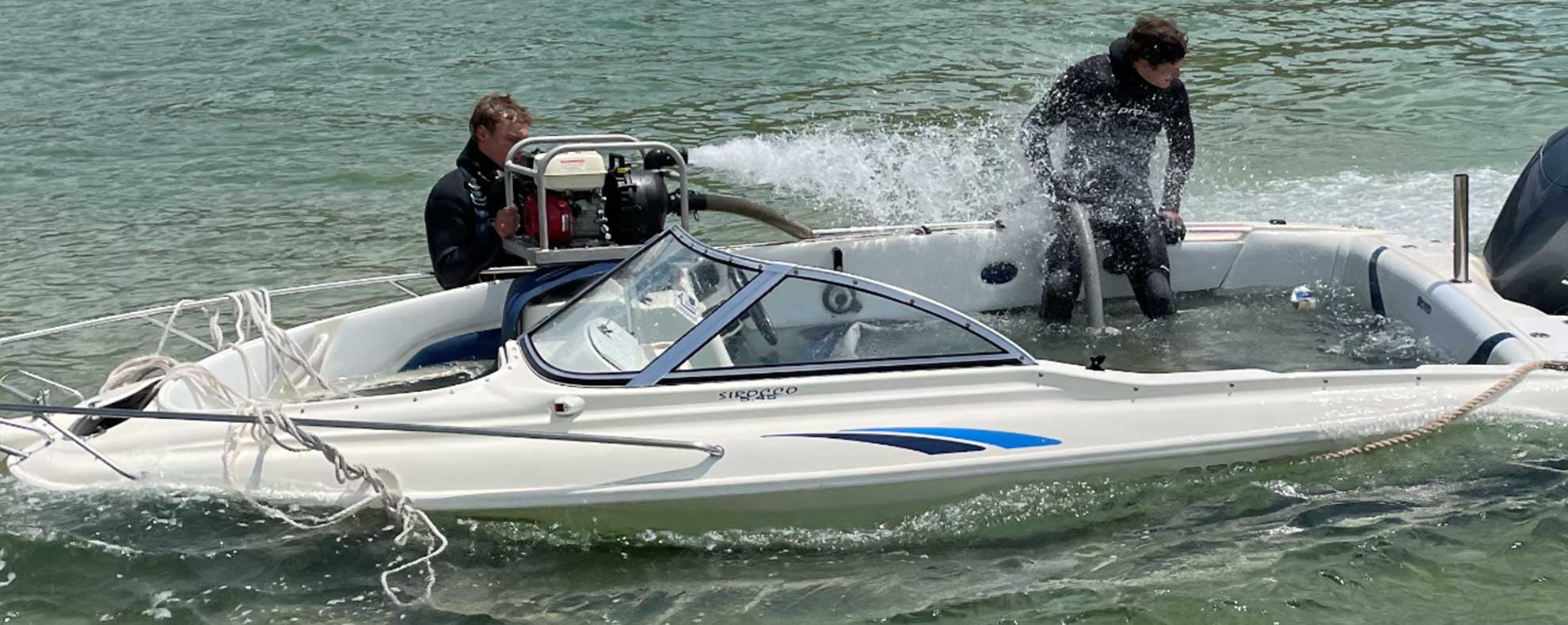 Mullies divers salvaging a speed boat that has filled with water